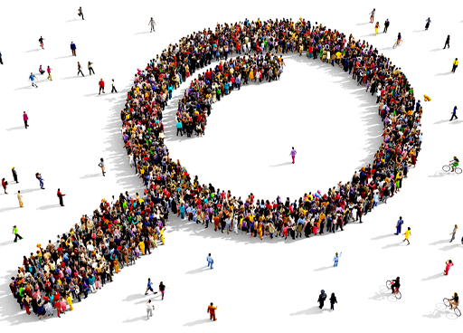 This is a photograph of a crowd of people who have formed to make the shape of a magnifying glass icon.