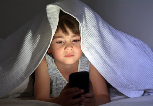 This is a photograph of a child using a smartphone.