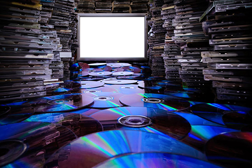 This image shows hundreds of discs in front of a computer screen.