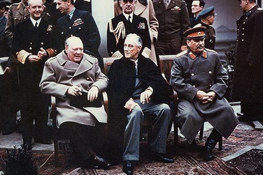 This is a photograph of (from left to right) Churchill, Roosevelt and Stalin sitting next to one another.