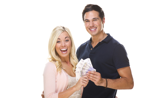 This is a photograph of a couple holding a handful of money.