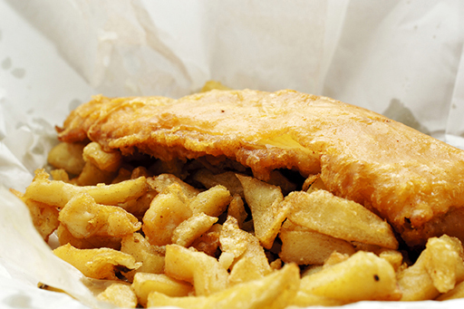 An image of fish and chips in a paper wrapper.