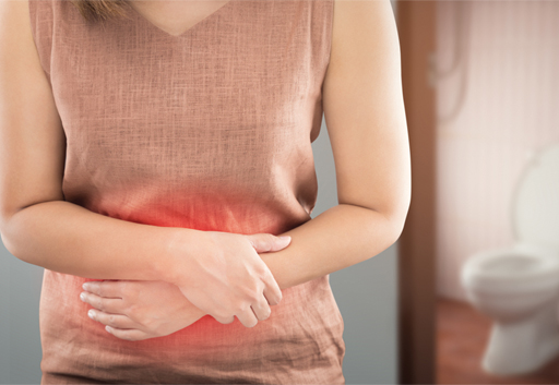 An image of someone holding their stomach, with red colouring centred on their stomach.