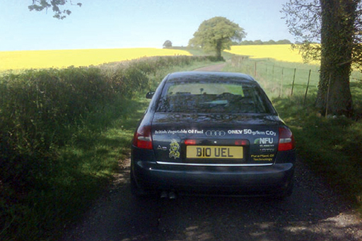 A car powered by vegetable oil against a background of oilseed rape fields