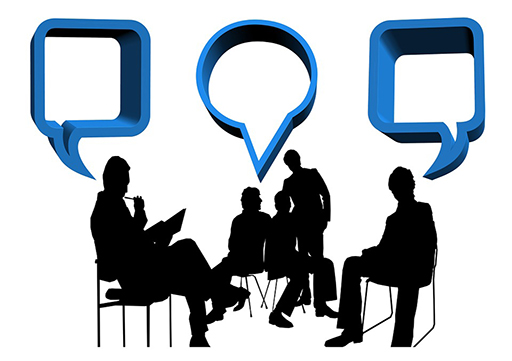 A silhouette of a group of five people in discussion sitting on chairs.