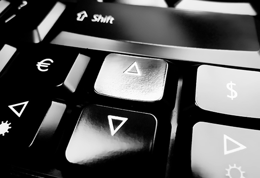 A close-up black and white photograph of part of a computer keyboard.