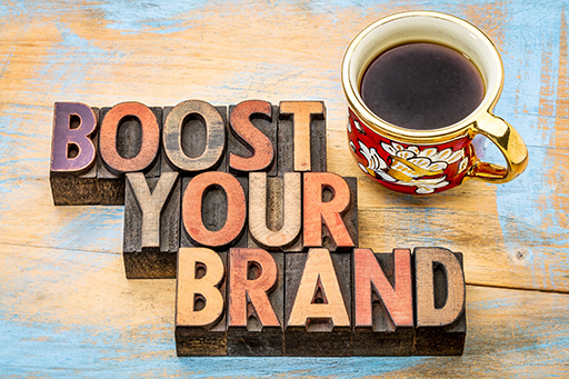 ‘Boost your brand’ is written using old printing blocks for each letter.