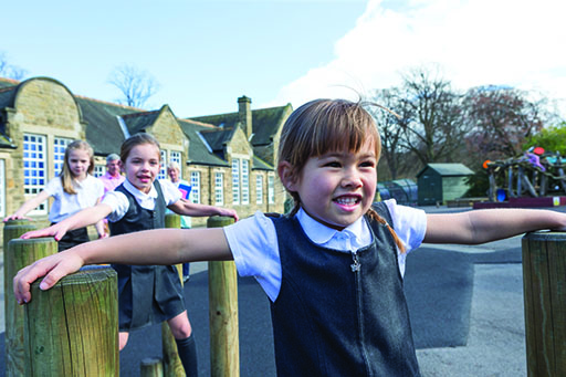 A photograph of a group of girls playing in a playground.