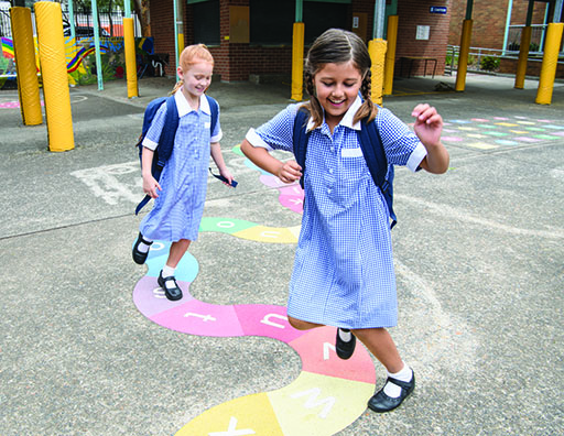 A photograph of two girls playing in a playground.