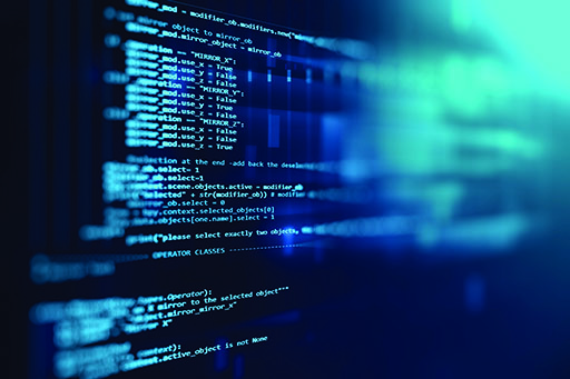 Coding is displayed on a screen.