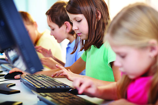 An image of children using computers.