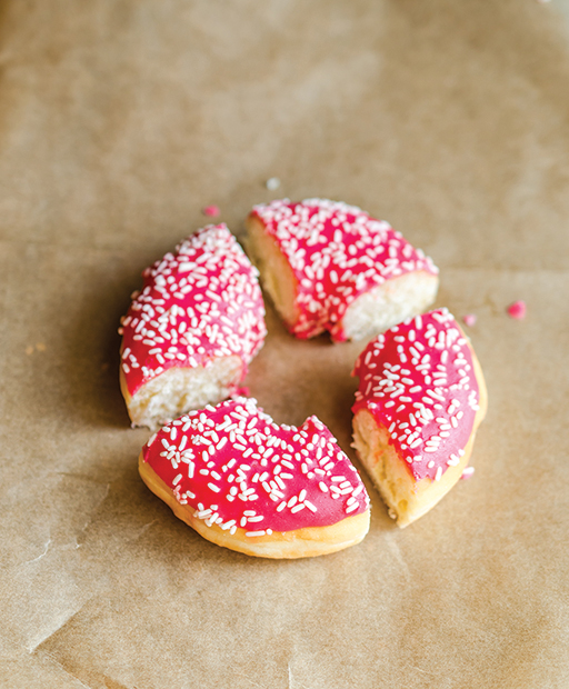 A donut cut into four equally sized pieces.