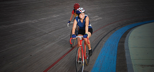 Two cyclists on a velodrome track