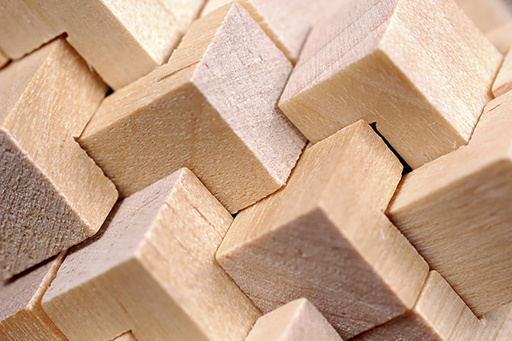 A close-up image of a cubes of wood interlaced, making a pattern
