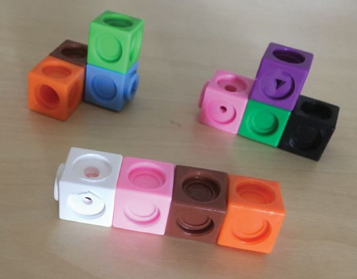 Three different three dimensional models which can be made using four multilink cubes.