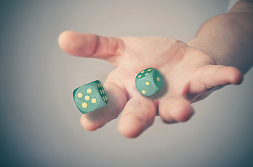 A photo of a hand holding a pair of dice.