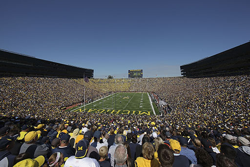 A photograph of a stadium packed to the brim with sports supporters at the University of Michigan.