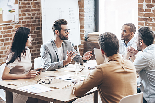 Photo of a group of people sitting round a table