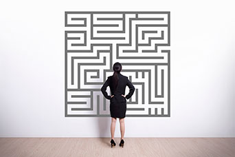 Woman studying an image of a maze