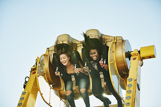 This is a photograph of two people on a rollercoaster.