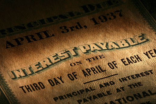 The figure shows a close-up of a bond certificate focusing on the details about the interest rate the bond pays.
