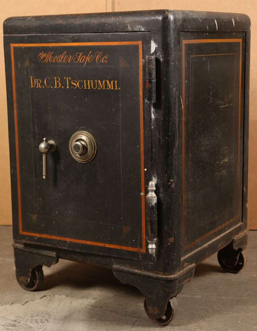 The image is a photograph of a large, and locked, safe.