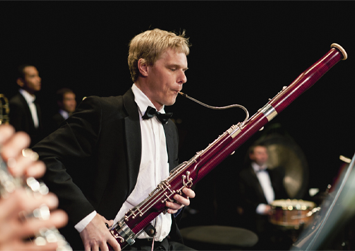 A musician playing the bassoon in an orchestra