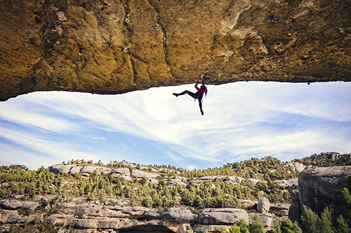 This is a photograph of a person rock climbing.