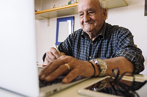 This is a photograph of a man at a computer.