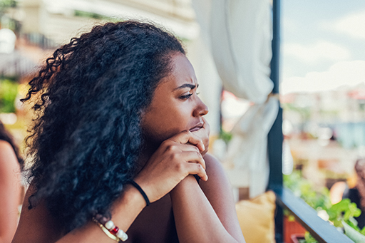 This is a photograph of a woman sitting outside.