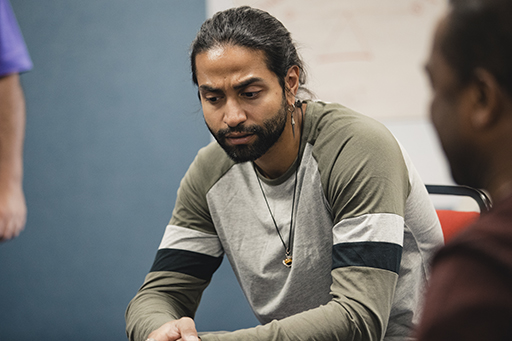 This is a photograph showing a group of people talking to each other.