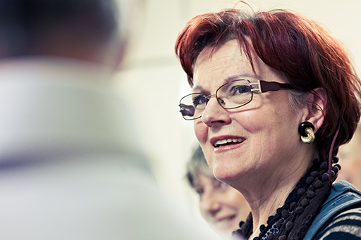 This is a photograph of three people in conversation.