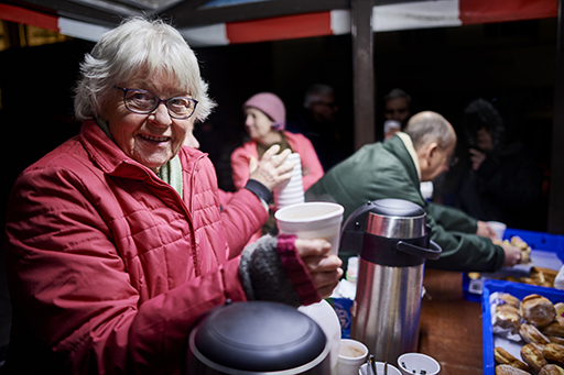 This is a photograph of a woman in a group of volunteers.