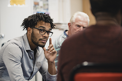 This is a photograph of a group of men in a therapy session.