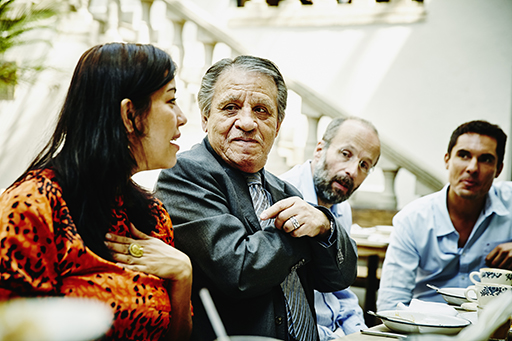 This is a photograph showing a group of four people talking to each other.