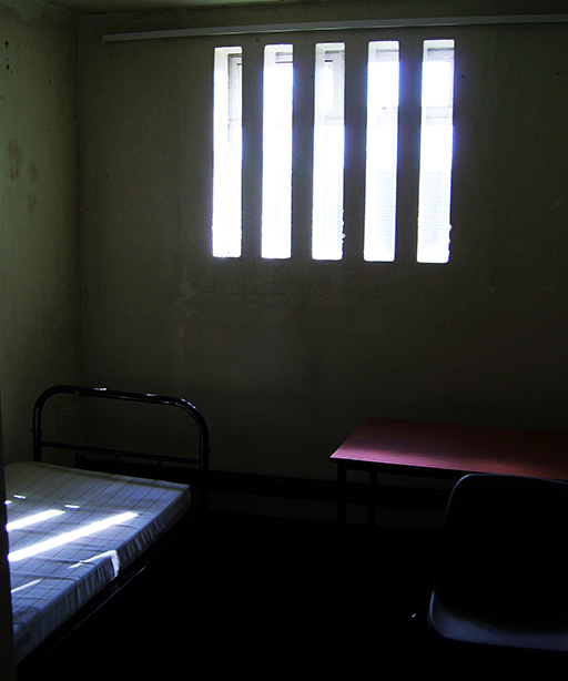 This is a photograph of the interior of a cell in the H Blocks showing a window and a bed.
