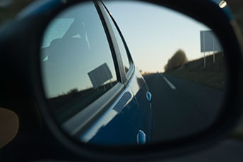 Looking back through a car wing mirror