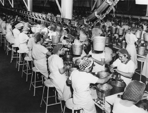 This is a black-and-white photograph of women working in a factory during the Second World War.