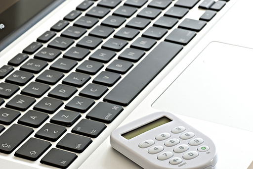 This image shows a computer keyboard and a small device used for internet banking.