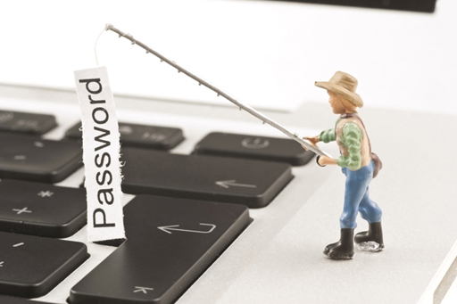 This image shows a figurine of a fisherman standing on top of a computer keyboard.