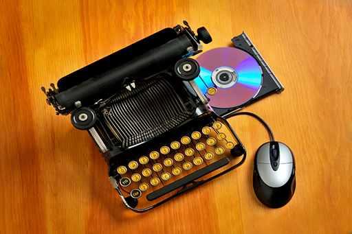 Image shows an old-fashioned typewriter, but with a DVD drive and a mouse attached.