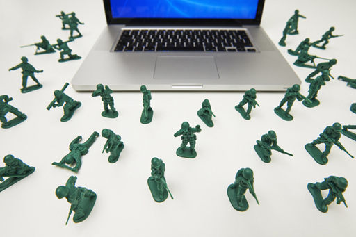 This image shows numerous toy soldiers guarding a laptop.