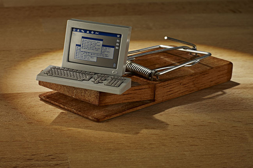 The image shows a computer on a mouse trap.