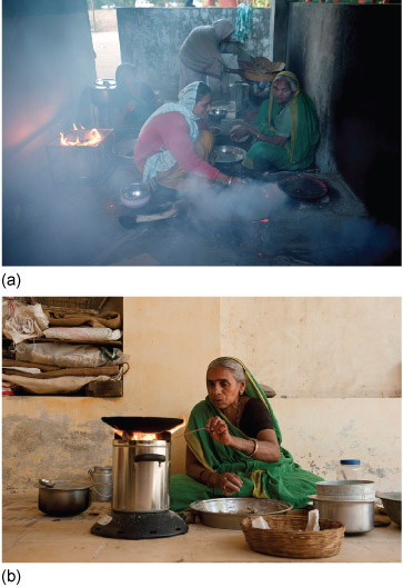 Figure 9a is a photograph showing several women in a room cooking with two biomass stoves - one is an open fire in an open-topped box; the other is obscured by smoke or steam. Figure 9b is a photograph that shows a woman cooking with a pan on an improved biomass stove, which is directing an intense flame onto a pan; no smoke can be seen.