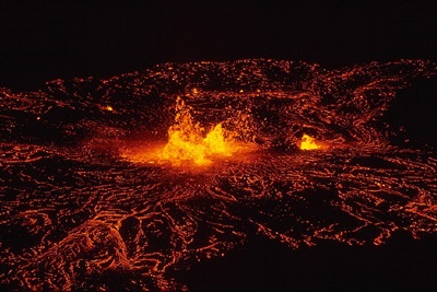 Image showing the Kilauea volcano at night. A close up that shows lava spurting from the crater.