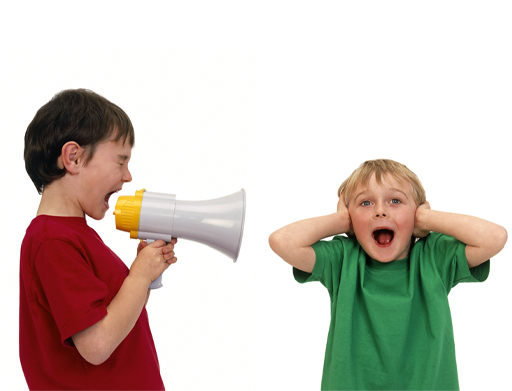 Photograph of a boy, on the left, shouting through a megaphone at another boy, on the right, who is covering his ears with his hands.