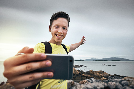 Young person taking a selfie with a smartphone.