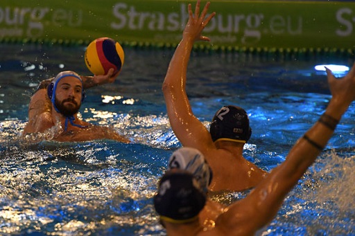 An image of four water polo players in the pool.