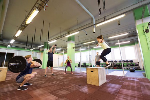 An image of males and females performing a range of power training exercises.