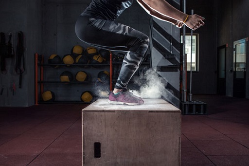 An image of a person jumping onto a wooden box